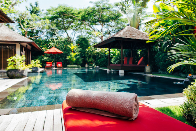 Towel On Red Sunbed In Luxurious Tropical Pool Villa