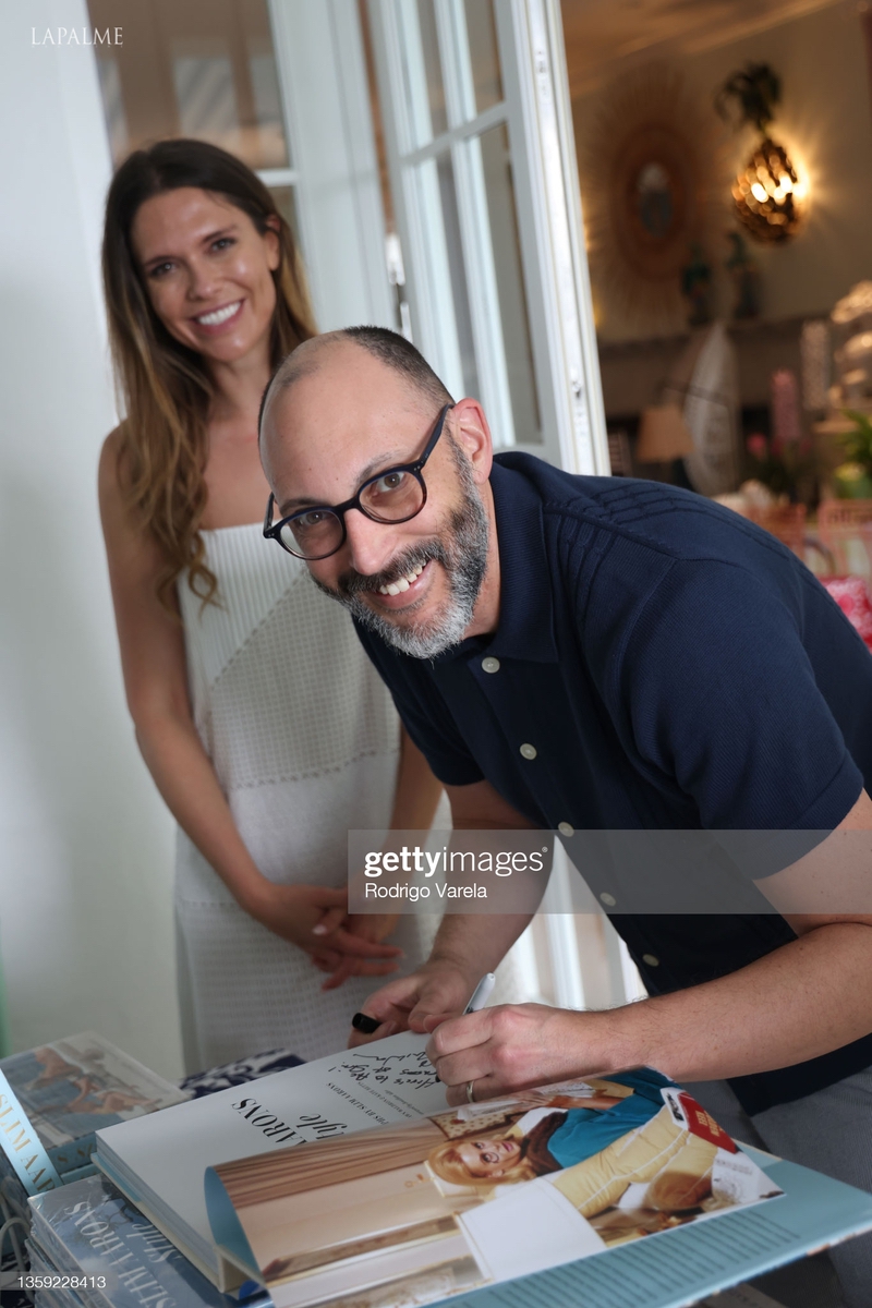 Bettina-Anderson-watches-as-Shawn-Waldron-signs-a-book